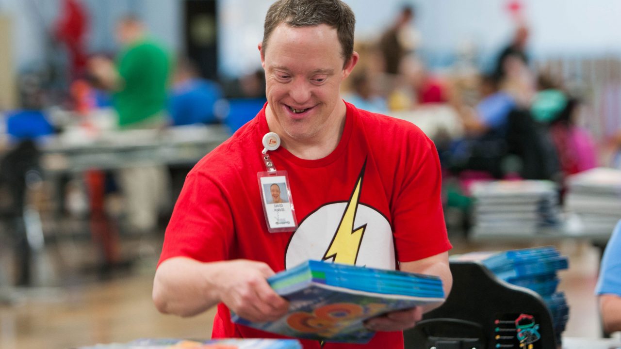 man smiling with a book