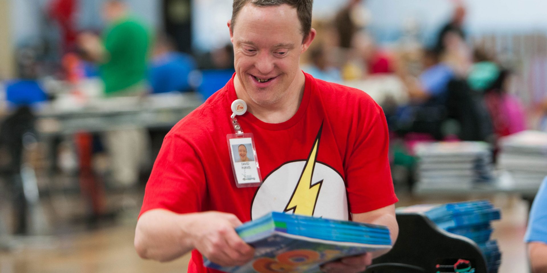man smiling with a book