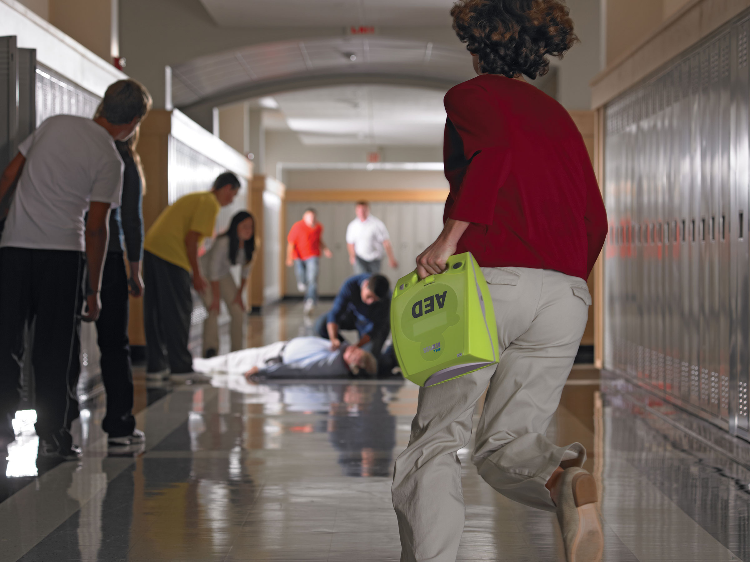 woman running to help man who is laying down