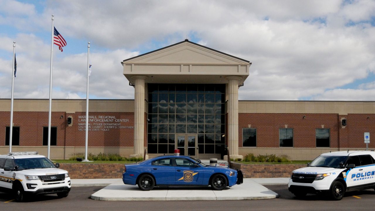 3 police cars in front of the law enforcement center