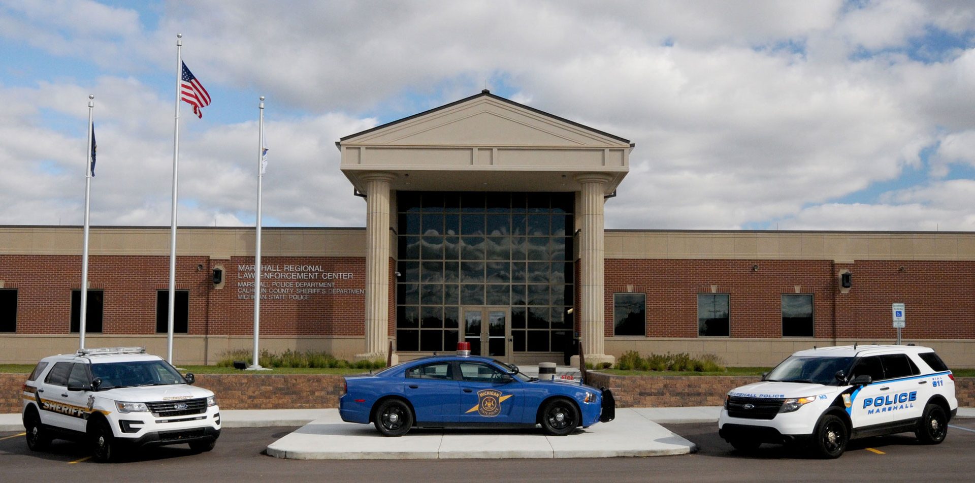 3 police cars in front of the law enforcement center