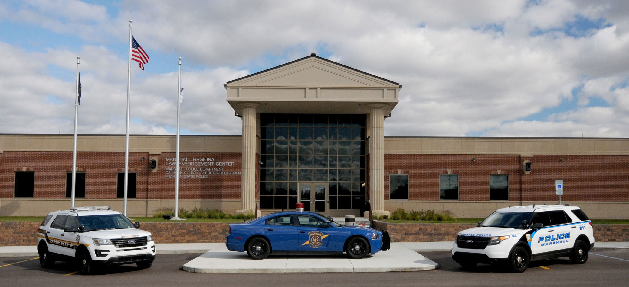 3 police cars in front of the law enforcement center