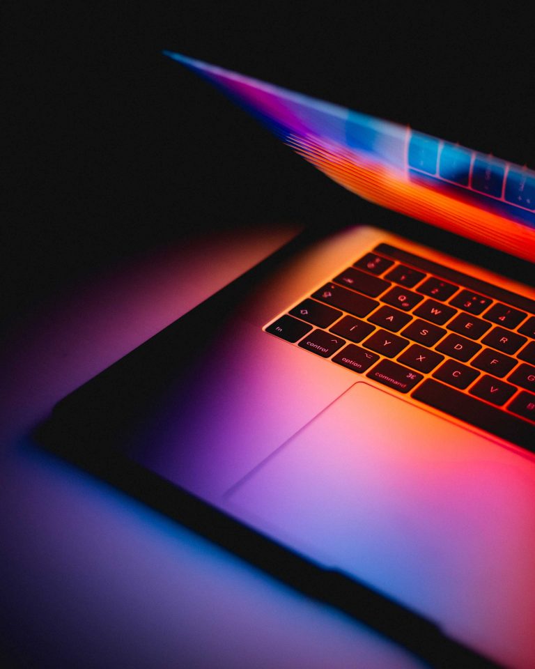 Colorful laptop in dark setting symbolizing Blayzer’s digital marketing support for IT companies.