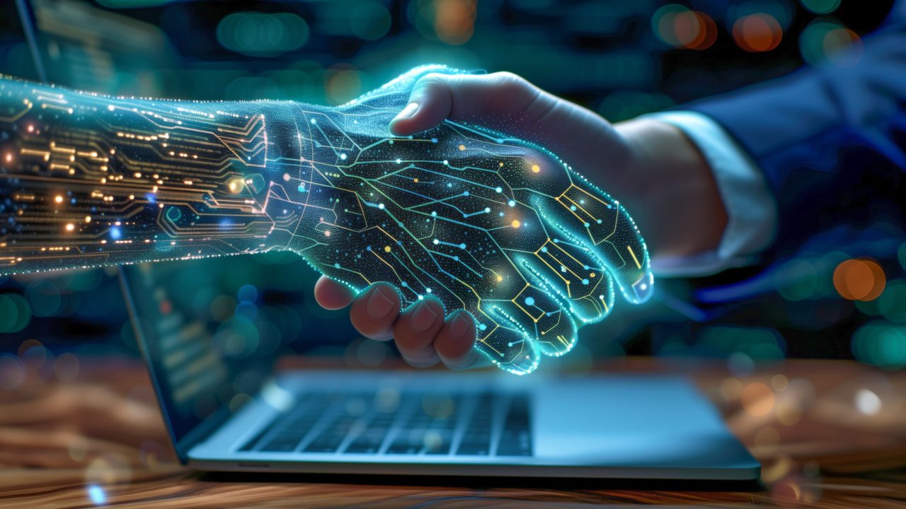 Blayzer Digital shows a glowing robotic hand from a laptop shaking hands with a person in a suit symbolizing AI and human partnership in ecommerce.