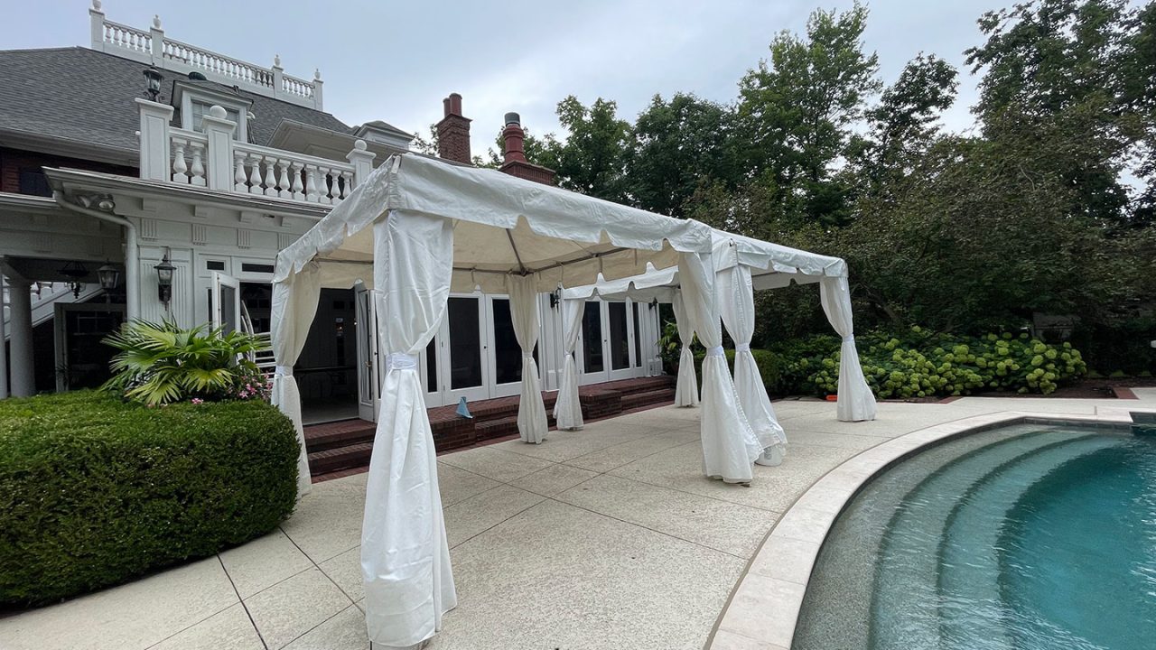 White event tent by a pool at upscale venue, showcasing 314 Event Rentals’ website powered by Blayzer WordPress design.