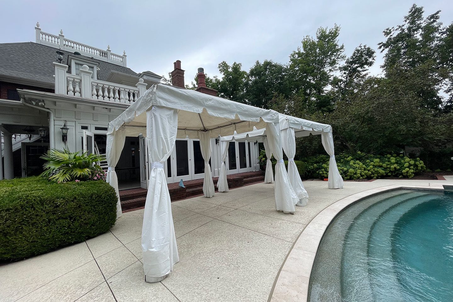 White event tent by a pool at upscale venue, showcasing 314 Event Rentals’ website powered by Blayzer WordPress design.