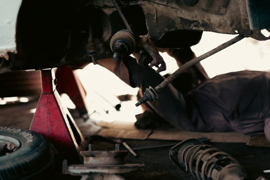 Mechanics working on vehicles in a busy auto parts and repair garage